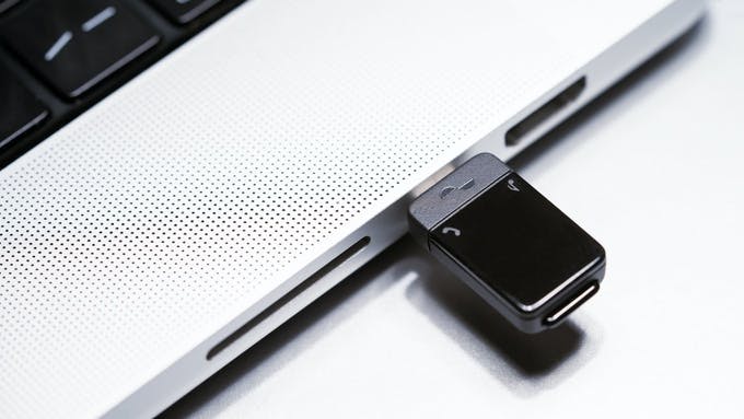 Nura Bluetooth® 5.3 Audio Transmitter inserted USB-C port of laptop